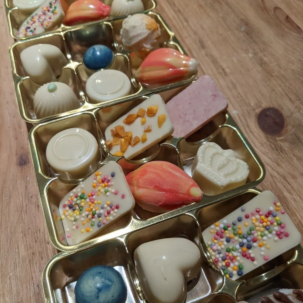 Decorated chocolates in a gold tray