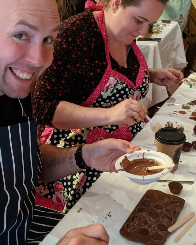 Guest in an apron at a chocolate making class