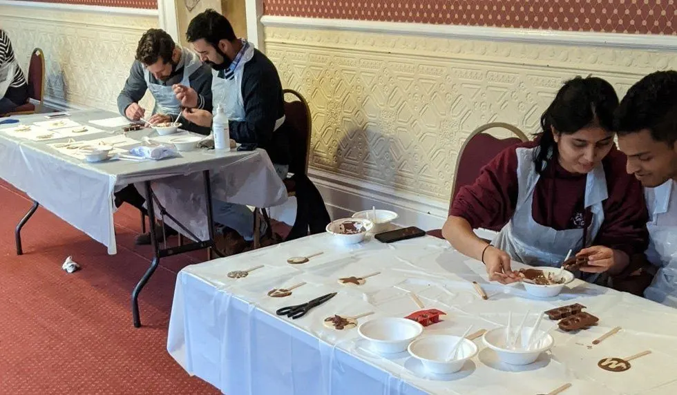 Two people making chocolates at a class